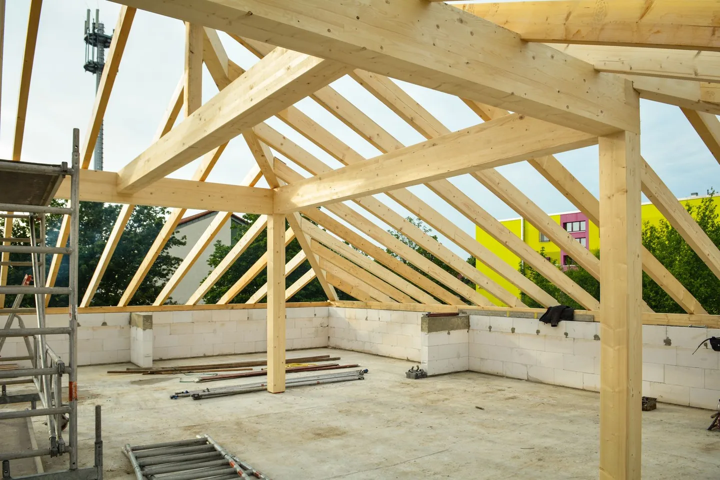 New timber roof trusses and rafters on a building under construction.